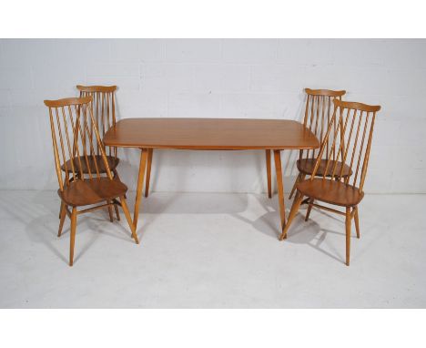 An Ercol blonde dining table with a set of four stick-back chairs - table measurements: length 152cm, depth 77cm, height 71cm