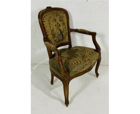 A French carver with tapestry back and seat and carved detailing.