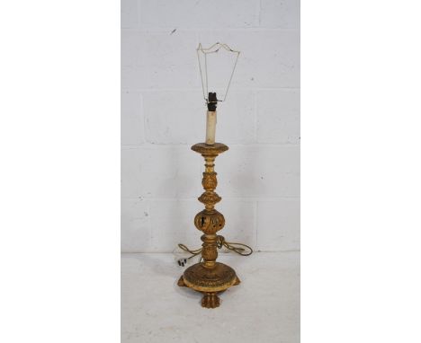 An Ecclesiastical style gilt table lamp, with carved acanthus decoration, raised on claw feet