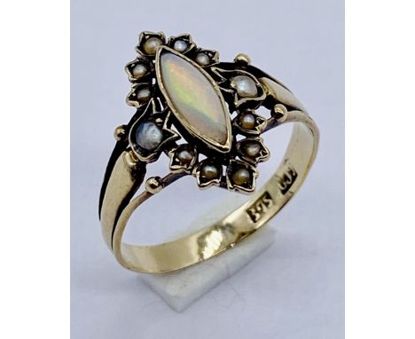 A Victorian 9ct gold ring set with an opal with a surround of seed pearls