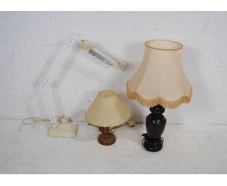 Two wooden table lamps, along with an angle-poise style adjustable lamp 