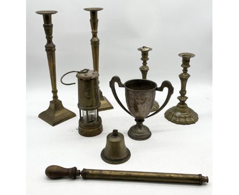 A collection of brassware including two pairs of candlesticks, miner's lamp by Lamp & Limelight along with a silver plated tr