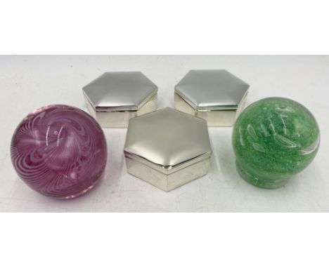 Three hexagonal silver coloured trinket boxes along with a Cowdy paperweight and one other