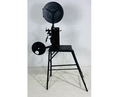 A 1930's hand crank film projector, a "Kalee Indomitable no 7" on hand made-stand