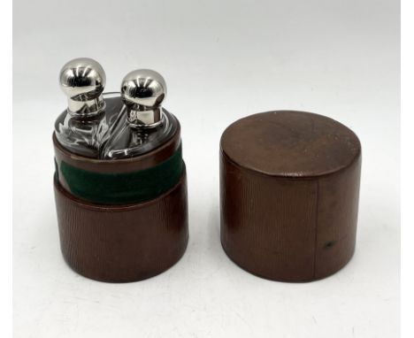 A leather cased double hip flask set with silver coloured tops