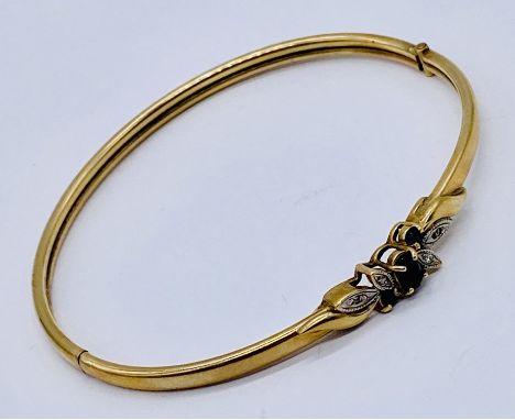 A 9ct gold hinged bangle set with diamonds and sapphires, weight 8.1g