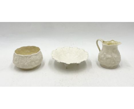 A Belleek sugar bowl and milk jug along with a Royal Worcester shell shaped pin dish on tripod legs