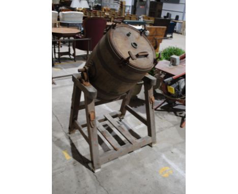 An antique wooden barrel butter churn, manufactured by 'Frank Buck' of Wincanton, with various prize plaques awarded to 'G. H
