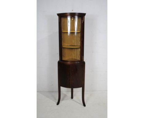 A Georgian style mahogany bow-fronted corner display cabinet, with upholstered interior, raised on splayed stick legs - width