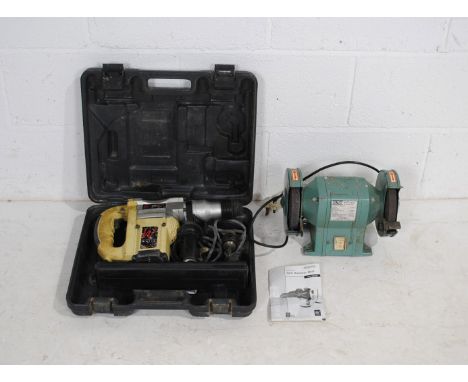 A boxed Axminster Power Tools AWSDS1050 hammer drill with instructions, along with a Kinzo 8E406 150mm bench grinder