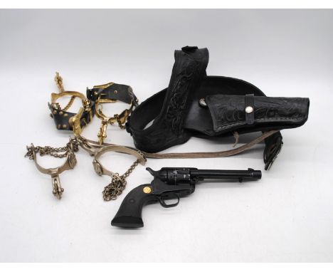 A Sussex Armoury Single Action Army Colt 45 replica, with black leather holster and bandolier, along with two pairs of stirru