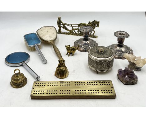 An assortment of items including brass cribbage board, vanity brushes, silver plated candlesticks etc.