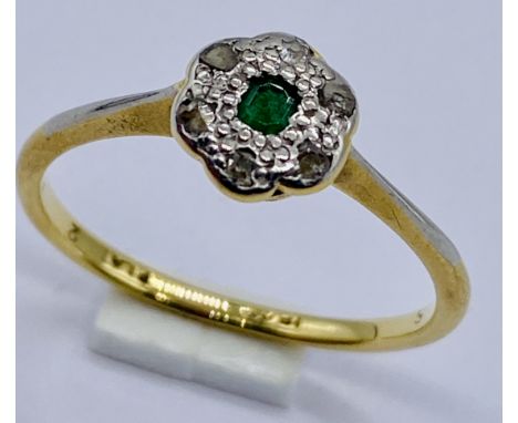 An 18ct gold emerald and diamond cluster ring, size O 1/2