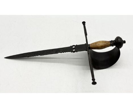 A wooden handled Toledo Main Gauche or left-handed dagger the steel guard decorated with scrollwork decoration