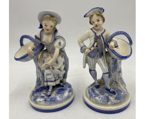 A pair of antique Royal Worcester blue and white porcelain figures modelled as a gallant and his companion, each standing wit