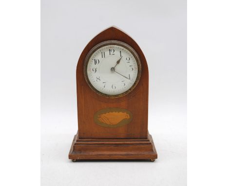 An Edwardian mantel clock, with inlaid central shell motif, raised on brass ball feet