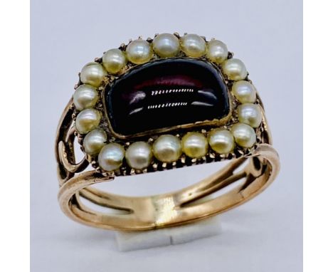 An unmarked gold mourning ring set with a cabochon garnet and seed pearls, inscribed " Elizabeth Nicholson, Ob 25 June 1811 a