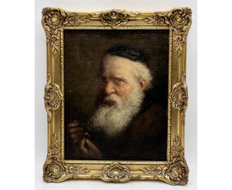 A small 19th century oil on board portrait of an older gentleman holding a ring and glasses, monogrammed to lower right (poss