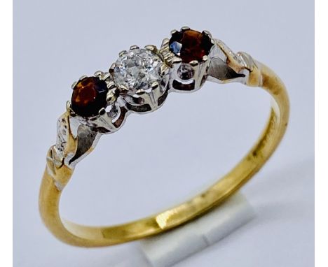 A diamond and garnet three stone ring set in 18ct gold and platinum, size S 1/2