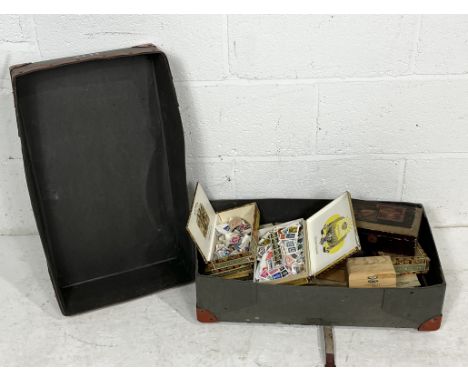 A large collection of loose stamps within a vintage case