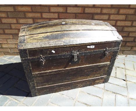 A metal bound dome top trunk, approximately 64 cm x 81 cm x 49 cm.