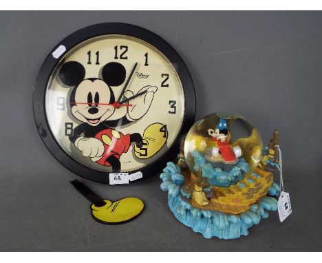 Disney - A Disney 'Fantasia' snow globe, approximately 16 cm (h) and a Mickey Mouse wall clock with Mickey's leg as pendulum.