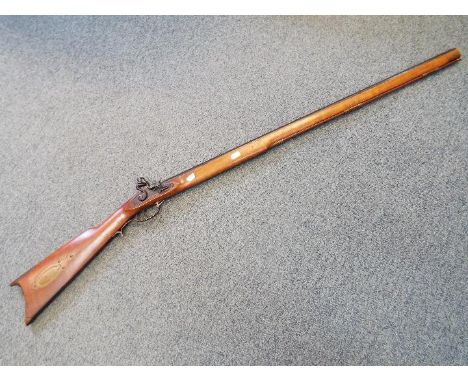 A replica Italian made Kentucky black powder flintlock hunting rifle in .45 cal. Some pitting to barrel with approx. 90% of b