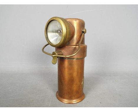A CEAG Miners Supply Co brass and copper lamp, type BE3, bearing broad arrow and engraved 'Liverpool Fire Service'.Condition 