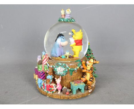 A Disney musical snow globe, Winnie The Pooh, approximately 21 cm (h).