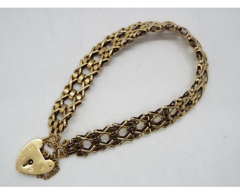 A gate link bracelet with padlock clasp stamped 375 and safety chain, 17 cm (l), approximately 12.7 grams all in.