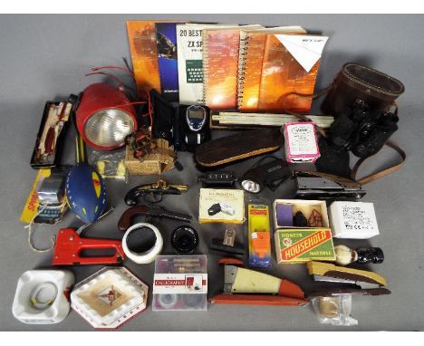 A mixed lot to include binoculars, a Signalling Company Ltd electric motor 4/6 volts in original box, vintage computer manual