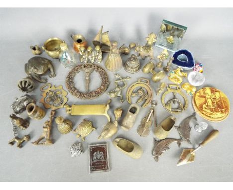 A collection of brass ornaments, a Vogue Vanities powder compact, silver plated trowel and similar.