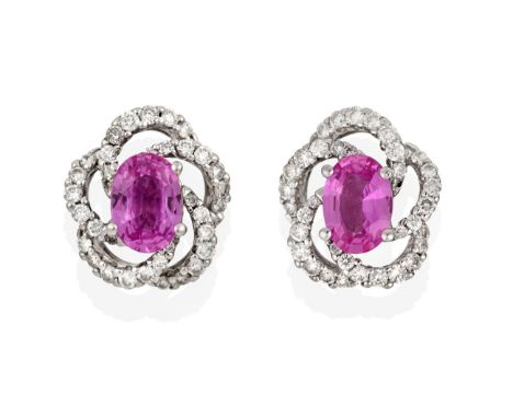 A Pair of 18 Carat White Gold Pink Sapphire and Diamond Cluster Earrings, the oval cut pink sapphires within a swirl border s