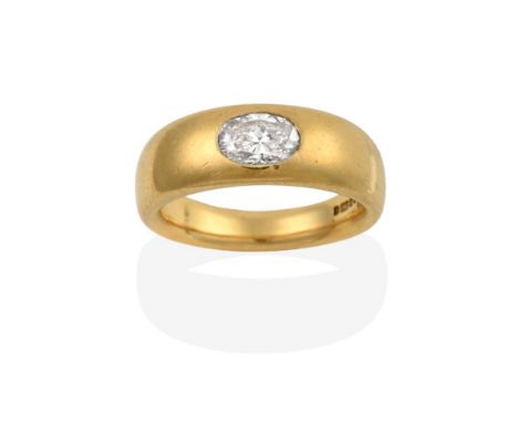 An 18 Carat Gold Diamond Solitaire Ring, an oval cut diamond inset into a yellow plain polished shank, estimated diamond weig