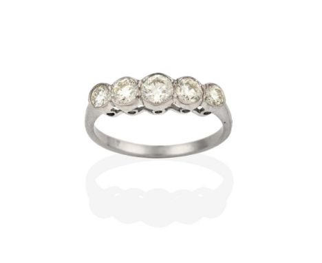A Diamond Five Stone Ring, the graduated round brilliant cut diamonds in white rubbed over settings, to a tapered shoulder pl