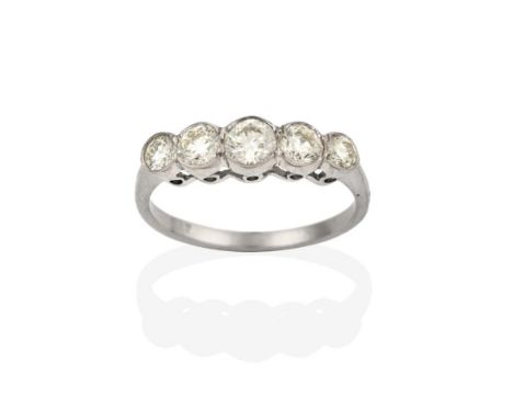 A Diamond Five Stone Ring, the graduated round brilliant cut diamonds in white rubbed over settings, to a tapered shoulder pl