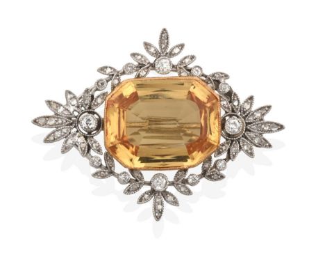 An Edwardian Diamond and Yellow Topaz Brooch, the rectangular cut yellow topaz in a yellow millegrain setting, to an openwork