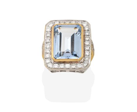 An Aquamarine and Diamond Cluster Ring, the emerald-cut aquamarine in a yellow millegrain setting within a border of eight-cu