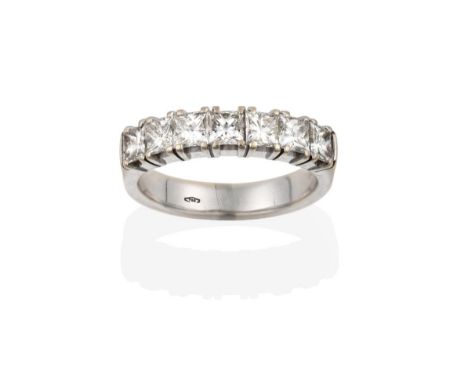 An 18 Carat White Gold Diamond Seven Stone Ring, the princess cut diamonds in claw settings, to a plain polished shank, total