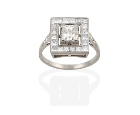 A Diamond Cluster Ring, the central princess cut diamond, in white claw settings, within a border of smaller square cut diamo