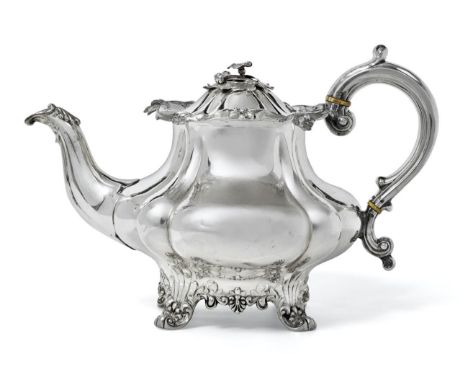 A Victorian Silver Teapot, by Joseph and John Angell, London, 1838, melon-fluted and on cast foliage and shell feet, with ivo