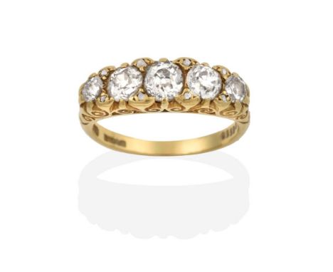 An 18 Carat Gold Diamond Five Stone Ring, the graduated old cut diamonds with rose cut diamond accents, in a yellow scroll ca