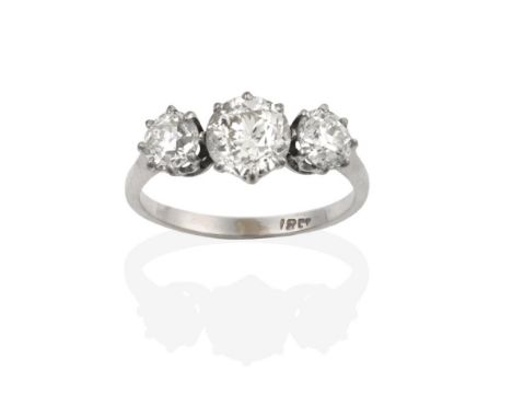 A Diamond Three Stone Ring, the graduated old cut diamonds in white claw settings, to a tapered shoulder plain polished shank