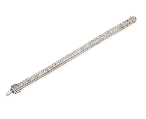 An 18 Carat White Gold Diamond Line Bracelet, formed of three rows, the central row of tapered baguette cut diamonds flanked 
