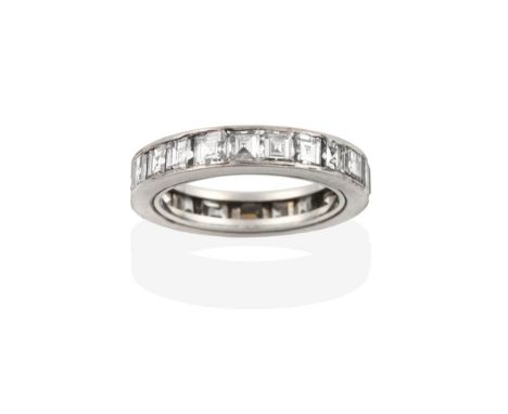 A Diamond Eternity Ring, the twenty-one square cut diamonds in a white channel setting, total estimated diamond weight 2.50 c