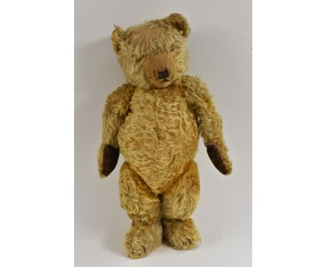 An early 20th century Teddy bear, possibly Chad Valley, long brown vertical stitched nose and mouth, centre seamed slight hum