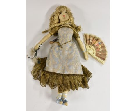 An Early 20th century hand made cloth doll, painted and stitched features, straw/ wood shavings stuffed body, long blond ring