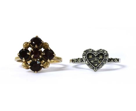 A 9ct gold garnet cluster ring, Birmingham 1965, 3.57g, together with a silver marcasite set heart ring (2)Finger size O½, Q