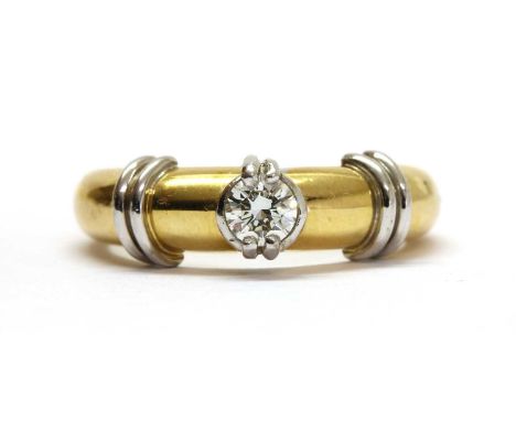 An 18ct gold single stone diamond ring, with a brilliant cut diamond, claw and bezel set in white gold, to yellow gold tapere