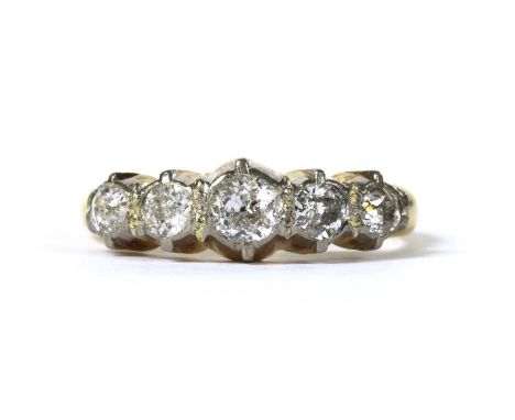 A gold five stone diamond ring, with a row of graduated old brilliant cut diamonds to tapered shoulders and a 'D' section sha